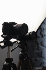 Video cameras on tripods, selective focus, Studio soft box, light. Filming, work of a videographer. hardware Radio microphone, receiver, directional microphone. Vertical photo - obrazy, fototapety, plakaty