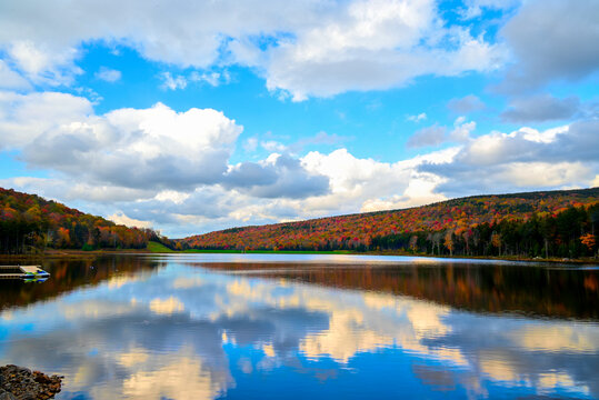Fall scene Shavers Lake in the Fall with blue sky and puffy white clouds