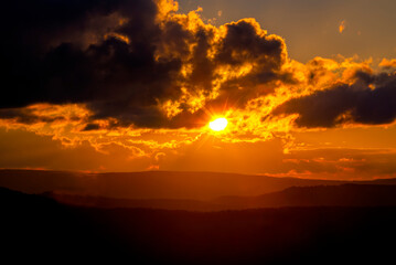 Sun setting on West Virginia Scenic Highway making orange sky