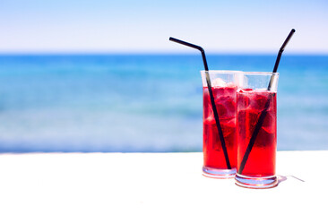 Cocktail glasses on sea background