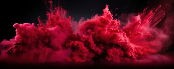 Explosion of ruby colored powder on black background
