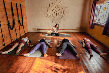 Yoga class lying down in in Corpse pose. Shavasana at end of class.