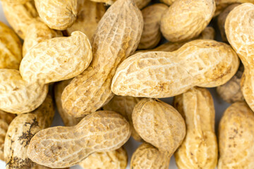 Top view of a bunch of dried peanuts in shell, delicious groundnut background. Nuts close-up. Healthy natural snack.