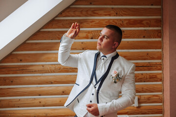 A groom holding wedding rings in his hands. Wedding traditions. Golden rings lie on the palm of a...