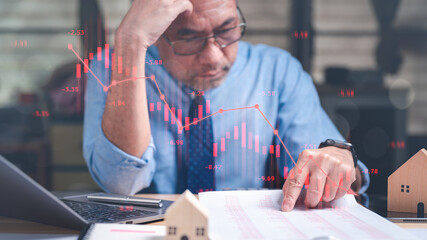Stocks concept. A stressed businessman, observing a graph with falling stocks, analyzes statistics...