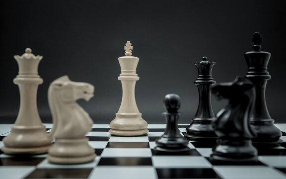 Black and White King and Knight of chess setup on dark background . Leader and teamwork concept for success. Chess concept save the king and save the strategy.