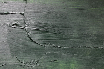 Overhead of mixed media backdrop. Plaster, wood and acrylic paint used. Variety of green, black and whites used to give a grunge look. Painted texture.