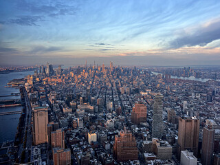 Aerial panoramic view over New-York skyline and Hudson river from One World Observatory deck at One World Trade Center, Winter Sunset