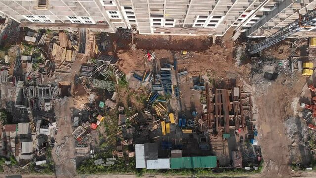 Construction of an apartment building filmed from the air. Copter rises to the top near the house