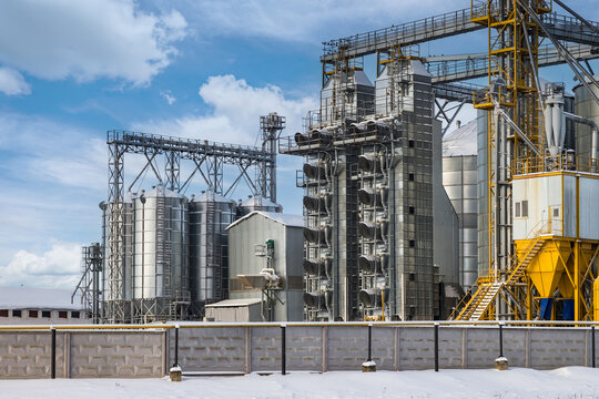 modern agro-processing plant for processing and silos for drying cleaning and storage of agricultural products, flour, cereals and grain in snow of winter field