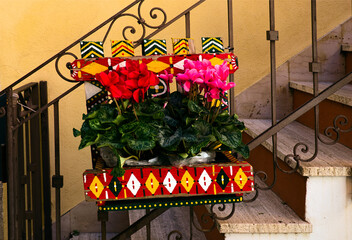 Close-up view staircase decorated by blooming potted flowers in Taormina, Sicily. Travel and tourism concept
