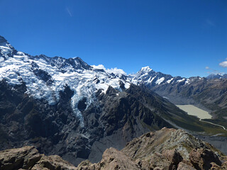 Mueller hut track, Aoraki National park, New Zealand. Southern Alps and Mt. Cook in the background, glacial lake in the front. Sunny day in the summer with clear skies and beautiful view.