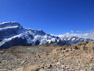 Landscape photograph of Mueller hut track, Aoraki National park, New Zealand. Southern Alps and Mt. Cook in the background. Sunny day in the summer with clear skies and beautiful view.