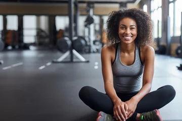 Fototapeten Gym, portrait or happy black woman on break after a workout, exercise or training for fitness. Funny, smile or healthy sports girl or female African athlete smiling or relaxing © Danko
