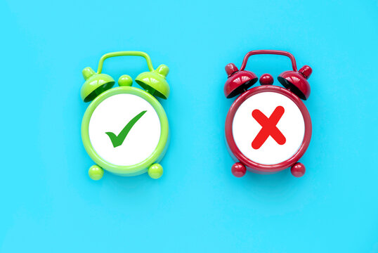 Concept of evaluation. True or false symbol. Accepted or rejected. Yes or no icon over a an alarm clock.	