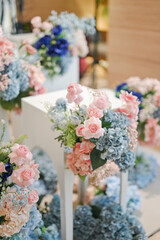 Modern chinese decoration for wedding ceremony or enggament. Blue pink rose. Indoors. Stage. Held on restaurant or ballroom. Chinesse caligraphic double happiness. Celebration. Private party. Dinner.