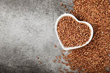 Buckwheat porridge in a bowl on a dark texture background. Healthy food. Diet. Organic cereal.
 Raw buckwheat. gluten free ancient grain for healthy diet. Place for text. Copy space.