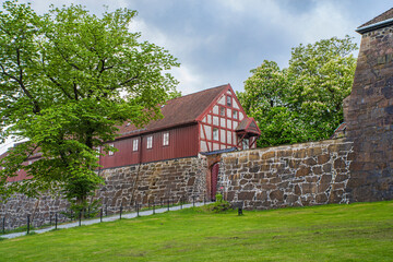 Half-timbered buildings near Akershus Fortress walls - 703417991