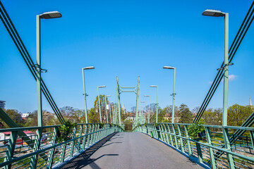 Pedestrian bridge over the river - 703418106