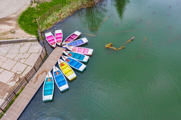 Colored boats docked, ready for tourists - 703418335