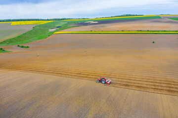 Aerial view of working tractor - 703418373
