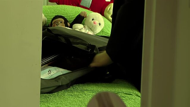 A Young Girl Closing Guitar Case in Her Bedroom at Home. Close Up.  