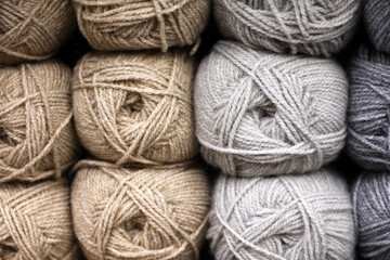 Grey and beige balls of wool, yarn for knitting and needlework