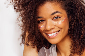 Charming african american with perfect skin and sequins on her cheeks