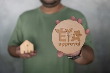 Man holding EIA approval or environmental impact assessment, considering the environmental impact...