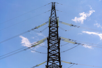 High voltage towers with sky background. Power line support with wires for electricity transmission. High voltage grid tower with wire cable at distribution station. Energy industry, energy saving