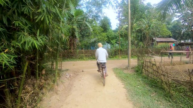 Video of an old Man cycling in a Village In Assam, India