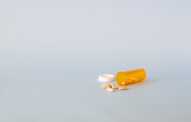 Scattered pills on a light background with copy space. Medication concept, pharmaceutical industry.