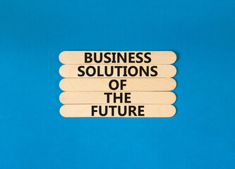 Business solutions of the future symbol. Concept words Business solutions of the future on wooden stick. Beautiful blue table blue background. Business solutions of the future concept. Copy space.