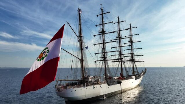 Aerial drone video of beautiful 3 mast barque or barc type classic sailing wooden boat anchored in Mediterranean deep blue sea