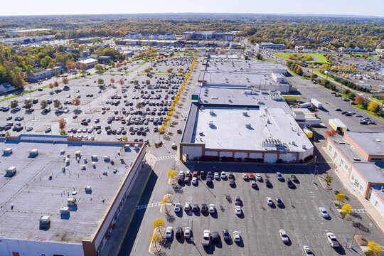 There is large parking lot with cars near shopping mall center in New Jersey, United States