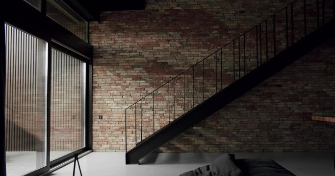 Modern apartment with black stair and large sliding windows , Minimalist Living room with Brick wall. Modern interior of loft apartment. brick room, interior texture, brick wall background with stair.
