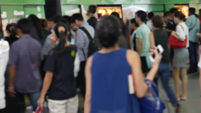 Asian commuters at the city train station 