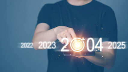 Casual business man touch screen Smart Tablet to enter the new year 2024, New corporate goal...
