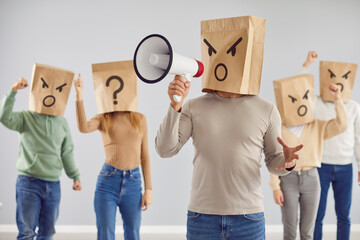 Angry frustrated disappointed mad emotional anonymous adult crowd protests with shopping bag...