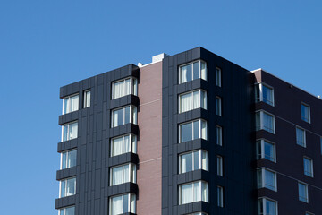 A modern apartment building on a blue sky