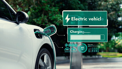 Electric car plug into EV charger cable from charging station display smart digital battery status...