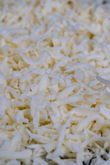 Obraz premium grated cheese in large quantities at home
