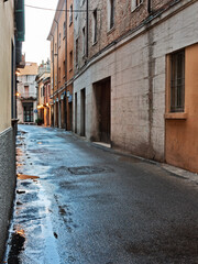 old town alley - dark city street after rain - 703470123