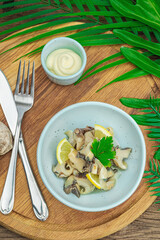 Rapana clam meat with oil, spices and greens. Healthy seafood is rich in omega. Marine decor