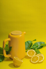 Lemon tea in ceramic tea pot with ripe fruits. Refreshment seasonal drink, conceptual background