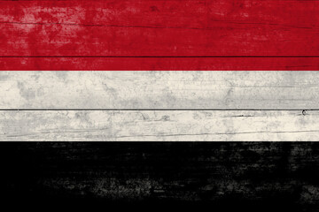 Yemen flag on a wooden surface. Yemen grunge flag.