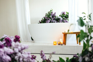 Modern bath room and spa center on the white tub wooden table.