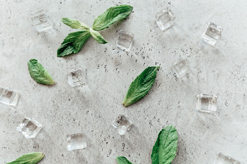 Mint leaves and ice cubes on table