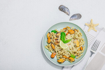 Plant based pasta with mussels, pesto and parmesan cheese. Ready to eat healthy food, served portion