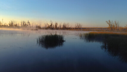 Obraz premium Colorful fog over the lake in autumn at dawn